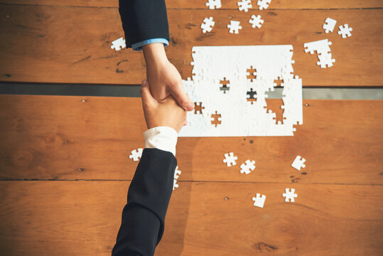 Business jigsaw puzzle connections strategy synergy team solution. Stakeholders business trusted communicate teams hands holding jigsaw puzzle synergy. Implement puzzle communication solve synergy