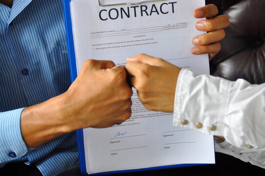 Trustworthy meeting business concept. Success collaboration partners sign contract and shake hands after success business joint venture deal. Shakehand teamwork partners at modern office handshake