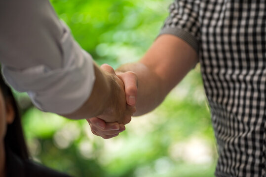 Team Businesswoman hands partners sign contract with success business deal. Partnership teamwork meeting signing contract business concept. Close up Diversity Businesswoman teams handshake together