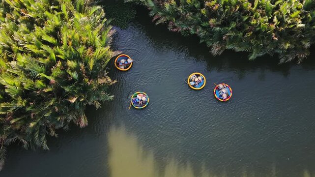 Aerial View Asian Guides Hoian Waterway. Line Of Colorful Coracles Drift Past Dense Palms In Slow Procession, Coordinated Movement, Photographic Panorama, Relaxed Exploration Tone.