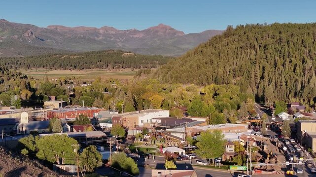 Aerial view of Pagosa Springs, Colorado aera fall landscapes capturing autumn colors and natural scenery of San Juan Mountains at golden hour sunset - 4K Drone