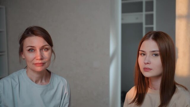 Caucasian coach giving focused exam feedback, in quiet apartment setting, two women facing each other with serious expressions, pronunciation drills and correction, steady sunlight casting warm