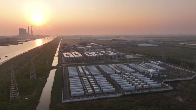 aerial view of industrial park with solar panels and power plant at sunset