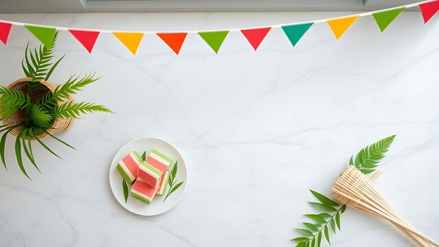 Overhead view of layered kuih, ketupat casing, and pandan leaves, Merdeka Malaysia National Day celebration concept.