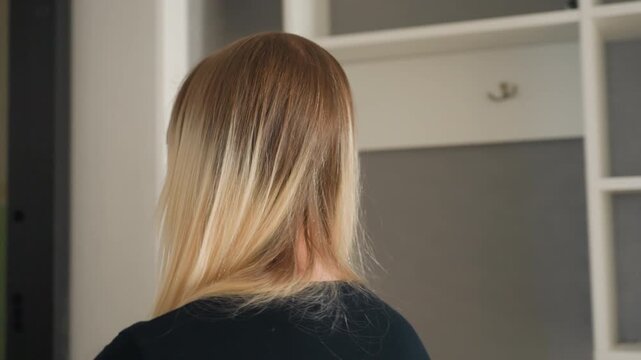 Young caucasian blonde standing in hallway and waiting for roommate, backview and profile shots show quiet anticipation, soft interior lighting, cloudshaped wall grid, peephole and doorway focus,