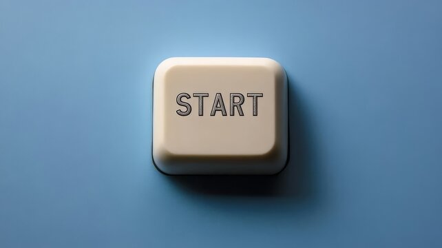 Close up of single white keyboard button with start text label isolated on a solid blue desktop workspace background surface.