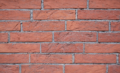 Obraz premium Uniform red bricks create a traditional wall pattern