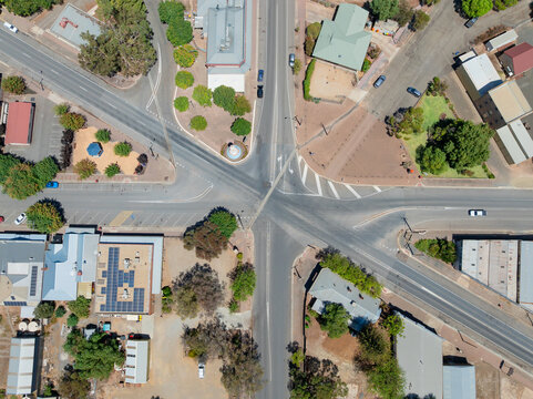 Aerial view of six roads entering an intersection in a rural town