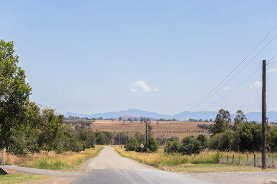 Rural sealed road changing to gravel surface