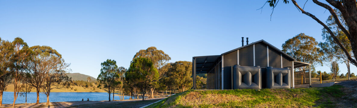 Water tanks beside amenities toilet and shower block building at lakeside campground