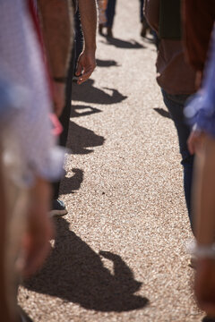 View of the road and people's arms and shadows in ANZAC Day march