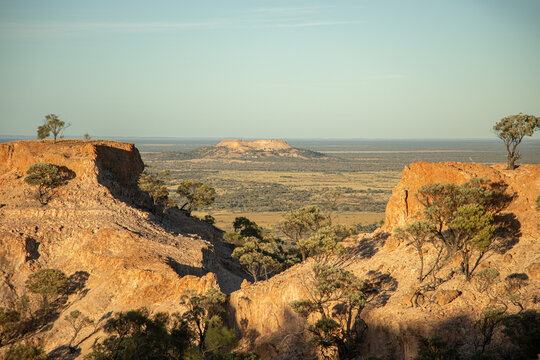 Distant mesa hill framed by two close mesa hills
