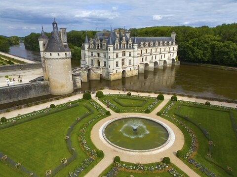 Castle and gardens with central fountain and geometric gardens by the river and under a cloudy sky, aerial view, Chenonceau Castle, Ch&acirc;teau de Chenonceau, moated castle, Chenonceaux, France