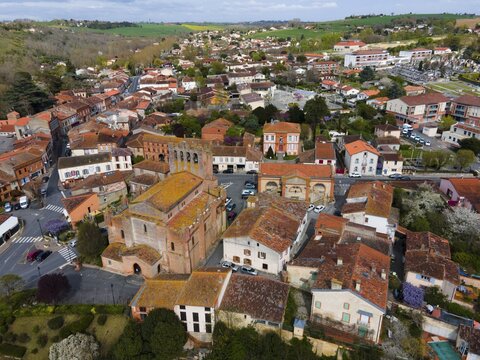 Aerial view of a small town with historic architecture and streets surrounded by landscape, parish church &Eacute;glise Saint-Pierre-et-Saint-Ph&eacute;bade, Venerque, Haute-Garonne, Occitania, France