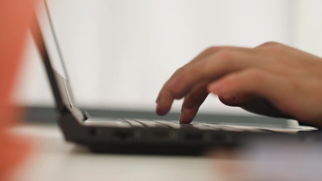 Closeup caucasian hands typing laptop on white desk, soft natural backlight, slow deliberate keystrokes showing freelance writer, remote editor proofreading, student drafting essay, novelist outlining