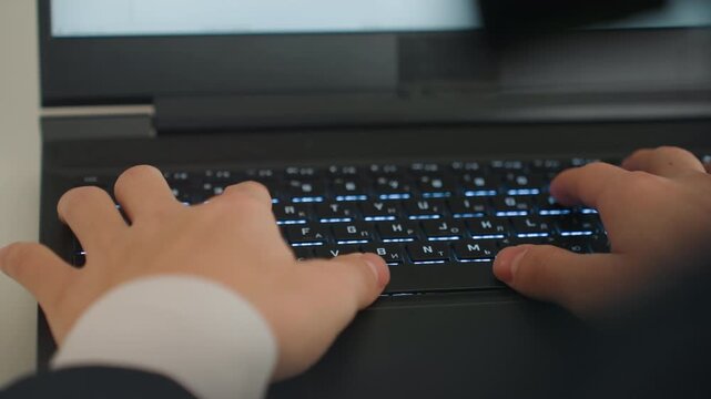 Closeup hands typing backlit laptop keyboard, focused executive in suit, rapid keystrokes and blurred motion, blue glow on fingers, tense deadline energy in dim office, cybersecurity or coding task,
