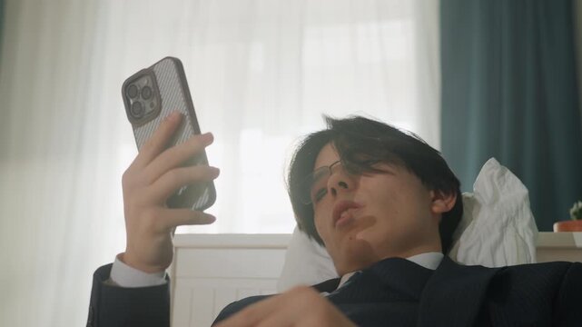 Young man in suit checking phone, soft window light backlighting face, closeup portrait angle, focused gaze and subtle expression, holding phone for email and video check, professional afterwork tone