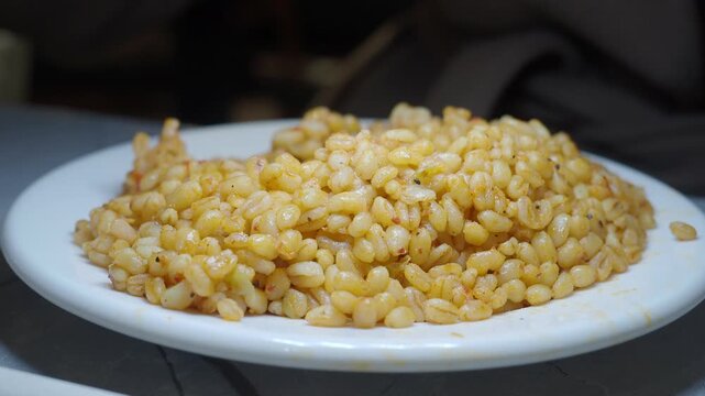 spoon pick bulgur rice on a table 