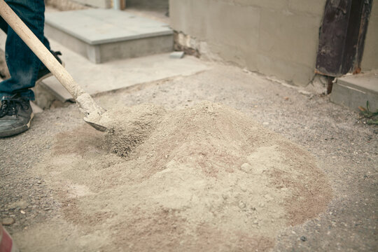 A construction worker works with a shovel