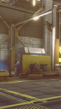 The scene shows a factory floor with yellow equipment set against a gray wall. Workers move around the area while machines operate. Various tools and machinery are in view.