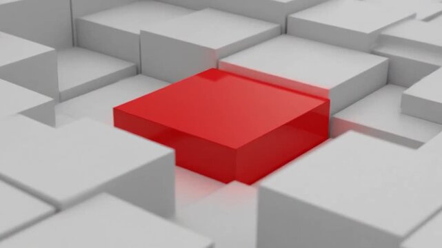 A single bright red cube stands out among many grey blocks
