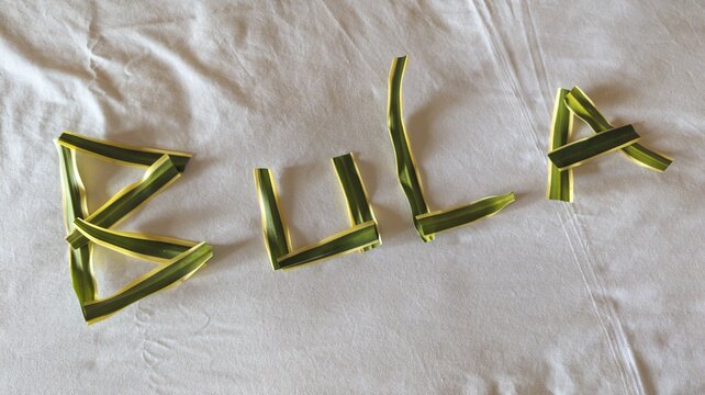 Beautiful homemade Fijian bula welcome message left on hotel accommodation bed during holiday vacation in Fiji