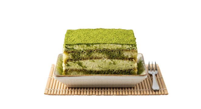 Layered matcha green tea tiramisu cake on ceramic plate