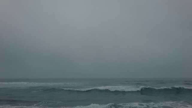 Rough waves crashing onto a sandy beach