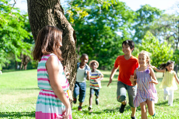 Fototapeta premium Children playing joyfully in park
