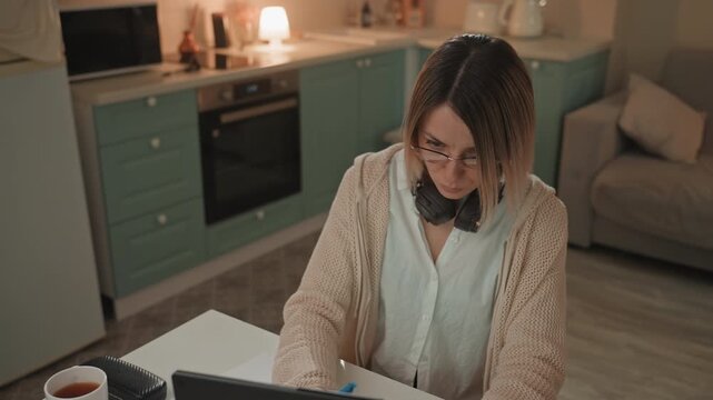 Nighttime musical inspiration. Woman writes songs during late hours. Silent night echoes with melodies and creativity. Female artist dedicates peaceful hours to songwriting and musical composing