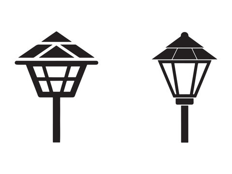 Two black outdoor lanterns with pyramid roofs on poles  modern garden lamp post designs