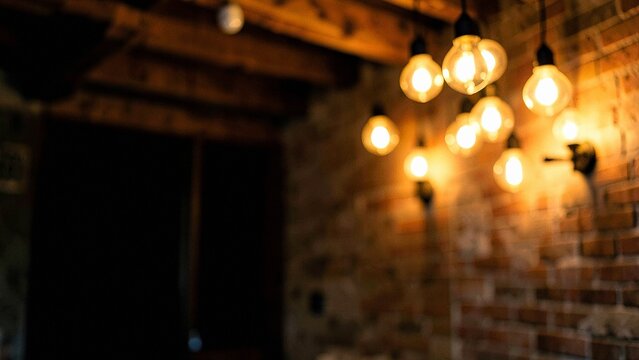 Dimly lit brick wall featuring warm glowing amber bokeh lights in a rustic interior