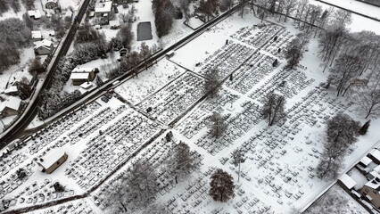 Fototapeta premium Winter wonderland view of a graveyard with a church