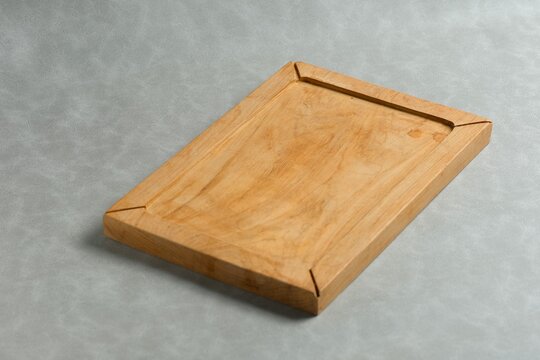 Wooden tray on gray background. Baki atau nampan kayu