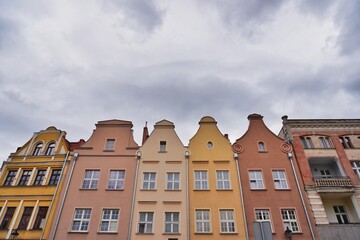 Fototapeta premium Colorful historic European townhouses with beautiful gables under a cloudy sky in a low angle view