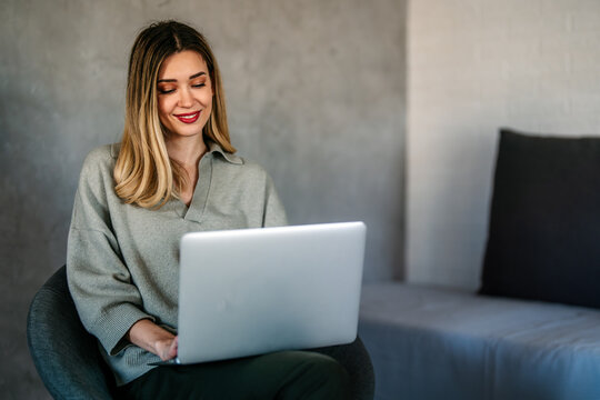 Woman working remotely from home office, having an online meeting, enjoying flexible freelance work