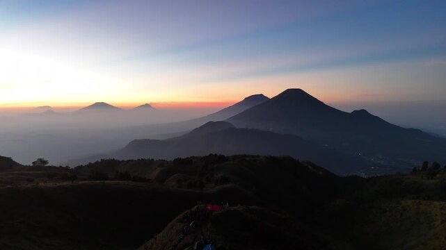 Aerial view of sunrise at the top of Mount Prau with clear sky.