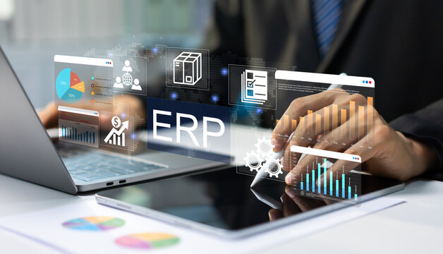 Businessman managing ERP software system on tablet and laptop with digital dashboards for enterprise resource planning and business analytics, workflow automation, business intelligence.