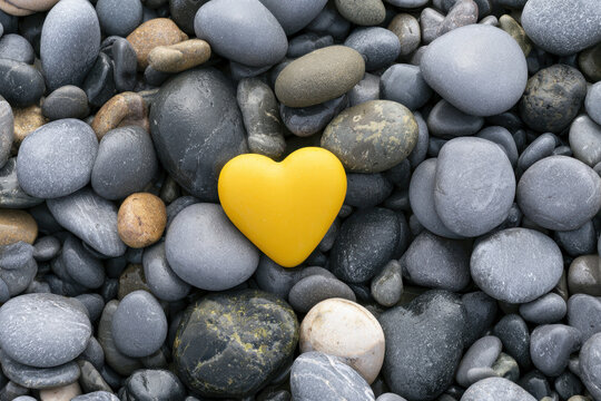 Close-up of a heart on a background of sea pebbles.