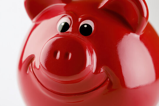 Close-up of a smiling red piggy bank