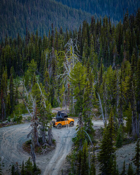 Yellow 4x4 with rooftop tent on a mountain road