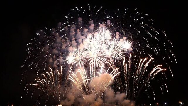 Spectacular colorful fireworks exploding in the dark night sky celebrating new year eve festival anniversary and major public holiday event grand finale display