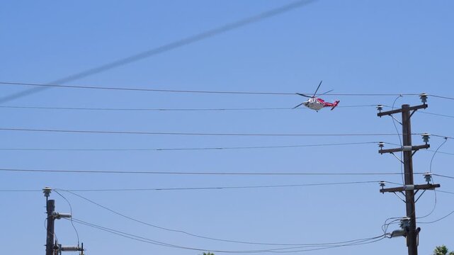 Slow motion shot of Los Angeles Fire Department responding to wildfire with aerial unit dropping water 