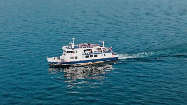 Passenger vessel navigating Lake Garda, ferry route across open lake water, Italy