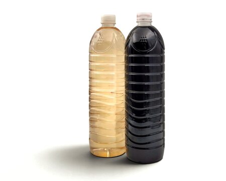 Photo of two traditional Greek bulk wines (Chyma), one red and one white, bottled in common local plastic containers and produced in the renowned Nemea region of Greece.