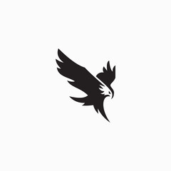 Fototapeta premium This logo features a minimalist silhouette of an eagle swooping or flying with its wings spread.