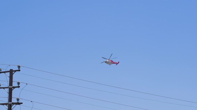 Slow motion shot of Los Angeles Fire Department responding to wildfire with aerial unit dropping water 
