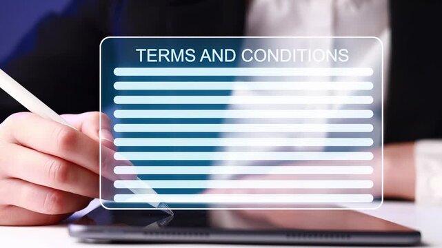 Person signs terms and conditions on a tablet with a stylus in a well-lit office at night.
