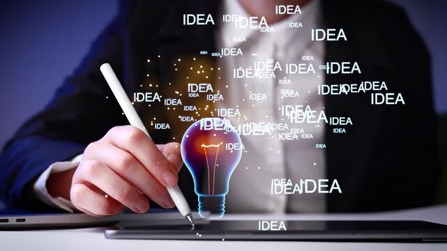 Person writing with hand on tablet while light bulb and ideas float in the air during a creative session at a desk.