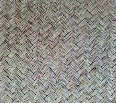 Woven matting made from esparto grass featuring a herringbone texture in neutral grey and beige tones
